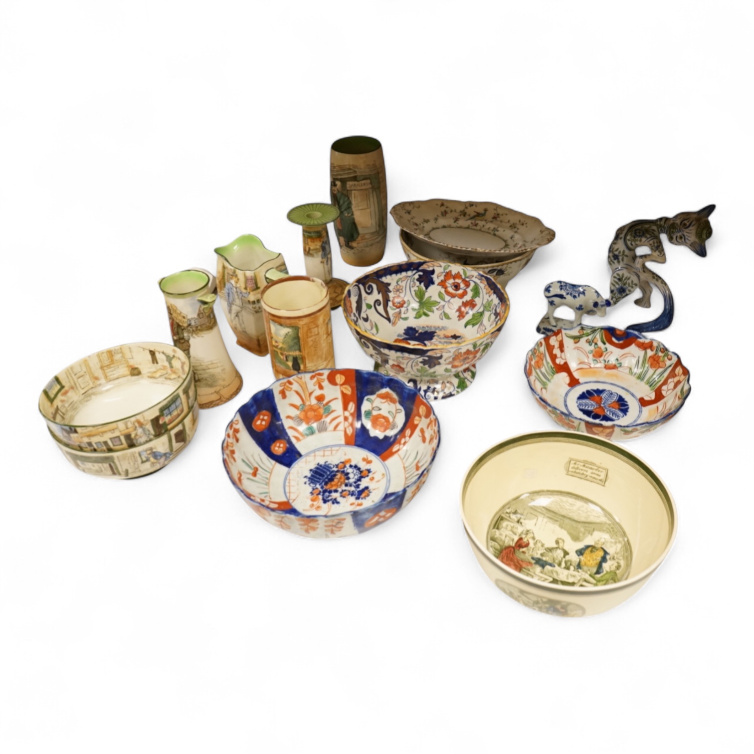 A collection of French, Japanese and English ceramics to include Royal Doulton Dickensware, Imari bowls and a faience glazed cat